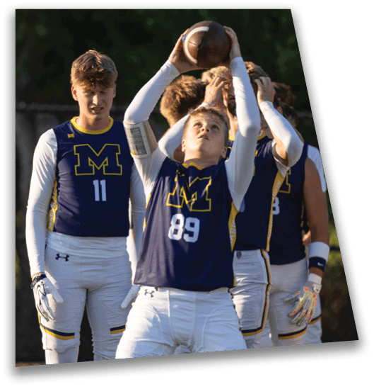 A group of young men wearing blue jerseys are playing football. One of the players is holding a football in his hands. AI generated content