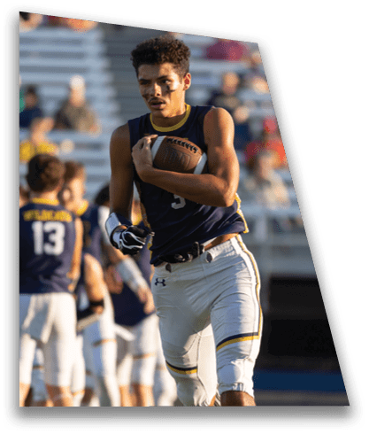 A football player in a blue jersey is running with a football in his hand. AI generated content