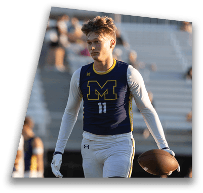 A man wearing a blue and yellow jersey with the number 11 on it is holding a football. AI generated content