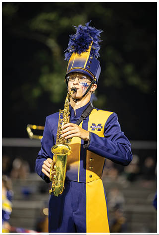 A man in a blue and yellow uniform plays a saxophone. AI generated content