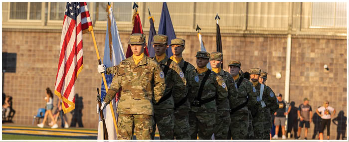 A group of soldiers in uniforms are standing on a field, holding flags. AI generated content