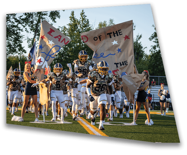 A group of football players marching on a field holding signs. AI generated content