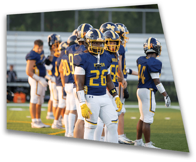 A group of people wearing blue and yellow football uniforms stand on a field, appearing focused and ready for a game. Description generated by AI