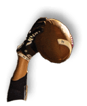 A person wearing a dark sleeve and glove is holding a football in the air against a blurred background. Description generated by AI