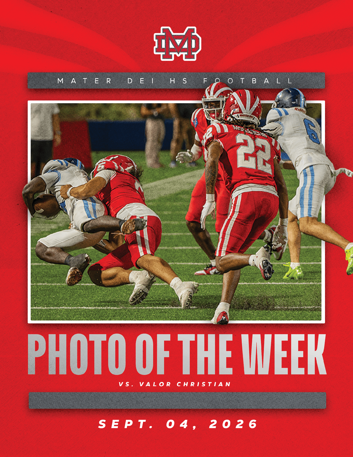 Two football players in red uniforms tackle a player in a white and blue uniform during a high school football game with other players nearby on a green field. Description generated by AI