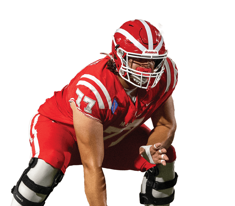 A person wearing a red football uniform and helmet is crouched in a ready position on a white background. Description generated by AI