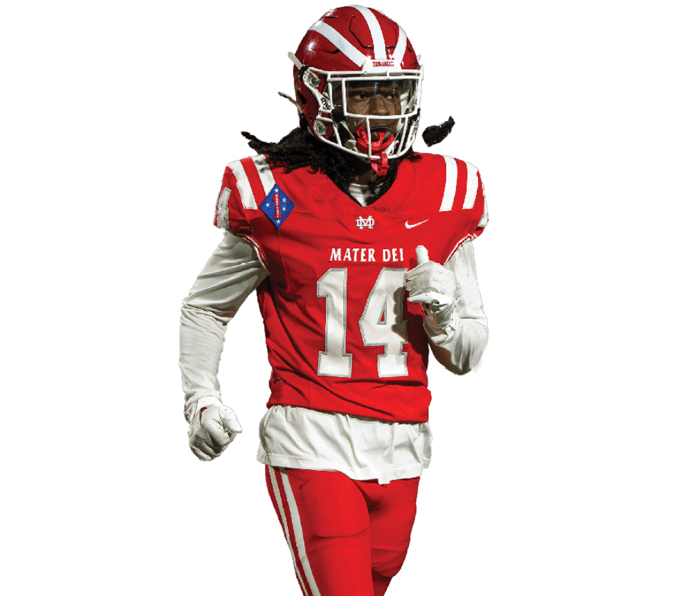 A person wearing a red and white football uniform with the number 14 is running. Description generated by AI
