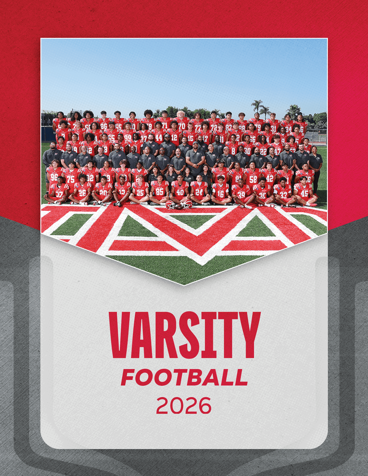 A large group of people wearing red and black football uniforms pose together on a football field with the word “VARSITY FOOTBALL 2026" displayed below them. Description generated by AI