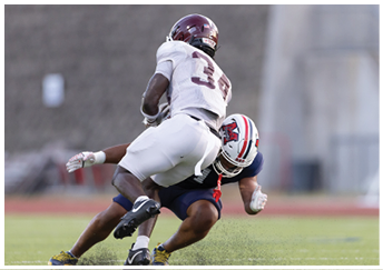 A group of football players on a field. Description generated by AI