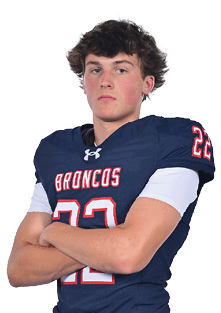 A young man wearing a white jersey with the number 10 on it. Description generated by AI