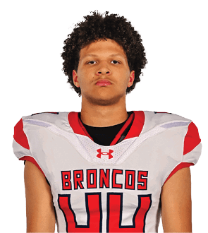 A young man wearing a white jersey with the number 10 on it. Description generated by AI