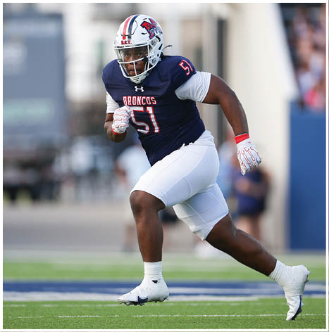A football player running on the field. Description generated by AI