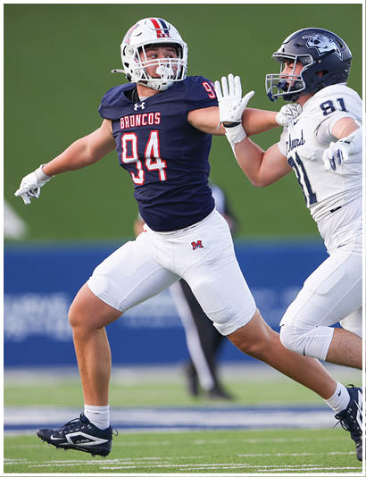 A football player wearing a blue jersey with the number 58 on it. Description generated by AI
