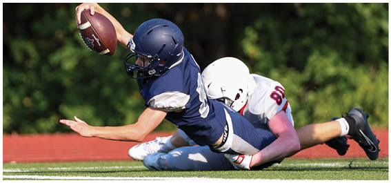 A football player is sliding on the ground. Description generated by AI