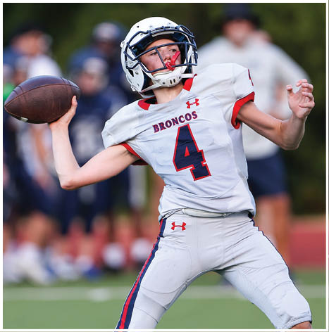 A football player running on the field. Description generated by AI