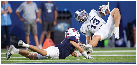 A football player is sliding on the ground. Description generated by AI
