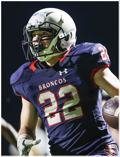 A football player wearing a blue jersey with the number 58 on it. Description generated by AI