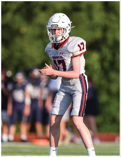 A football player wearing a blue jersey with the number 58 on it. Description generated by AI