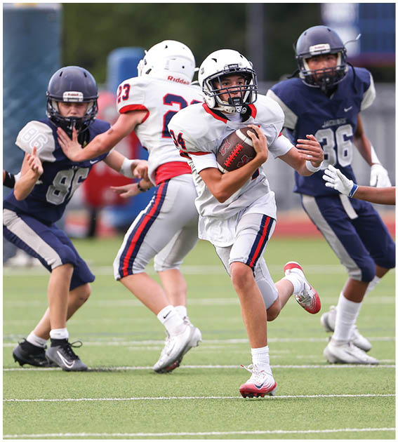 A group of football players wearing black and white uniforms. Description generated by AI