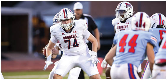A football player is sliding on the ground. Description generated by AI