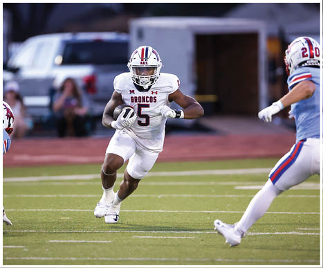 A football player running on the field. Description generated by AI