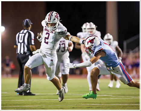 A football player running on the field. Description generated by AI