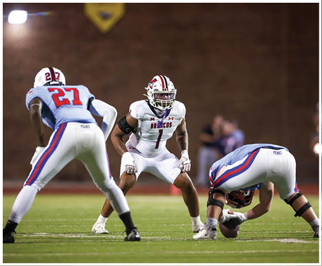 A football player running on the field. Description generated by AI