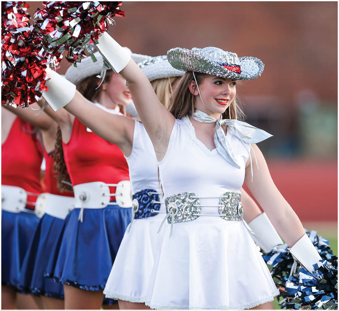 A football player wearing a blue and white uniform. Description generated by AI