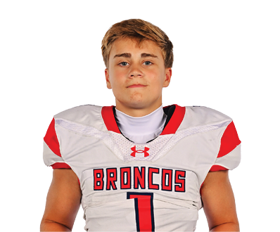A young man wearing a white jersey with the number 10 on it. Description generated by AI