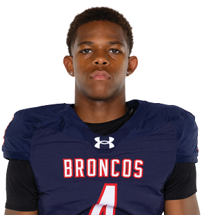 A young man wearing a white jersey with the number 10 on it. Description generated by AI