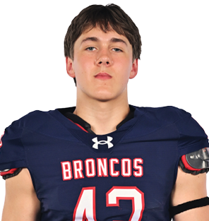 A young man wearing a white jersey with the number 10 on it. Description generated by AI
