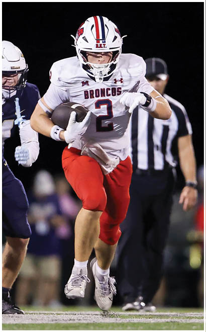 A football player running on the field. Description generated by AI