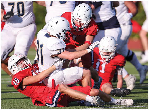 A football player is sliding on the ground. Description generated by AI