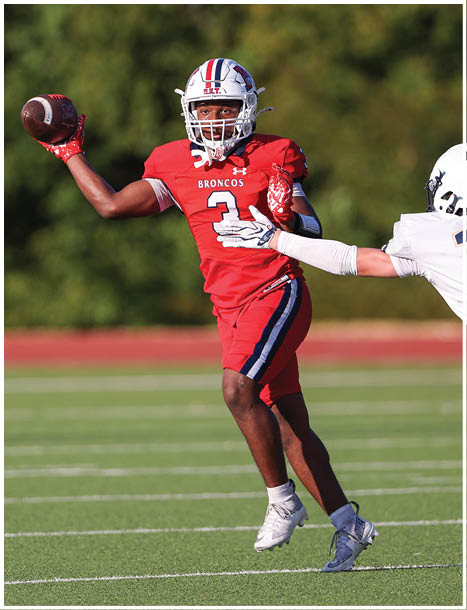 A football player running on the field. Description generated by AI