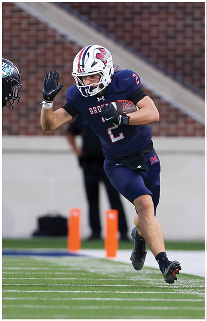 A football player running on the field. Description generated by AI
