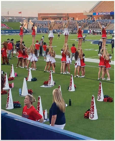 A group of football players on a field. Description generated by AI