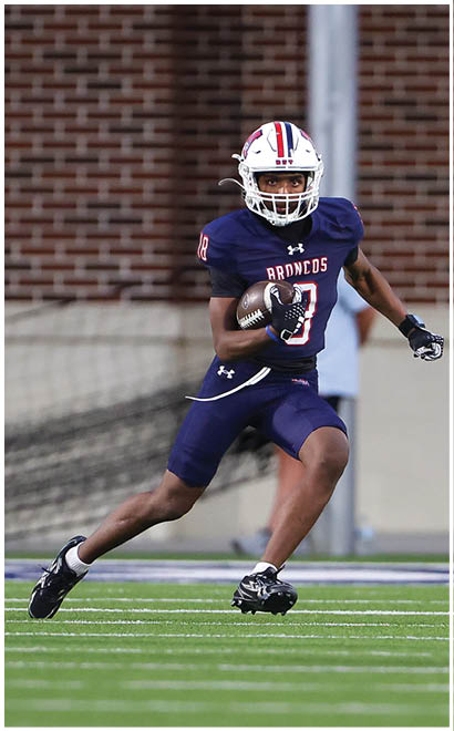 A football player running on the field. Description generated by AI