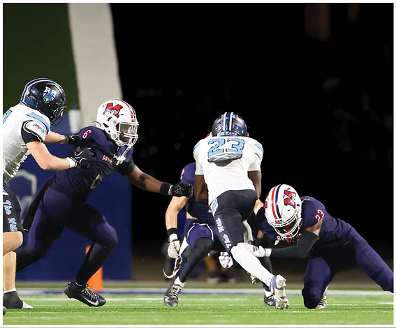 A group of football players on a field. Description generated by AI