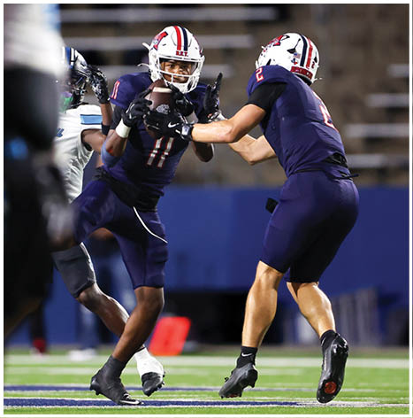 A football player running on the field. Description generated by AI
