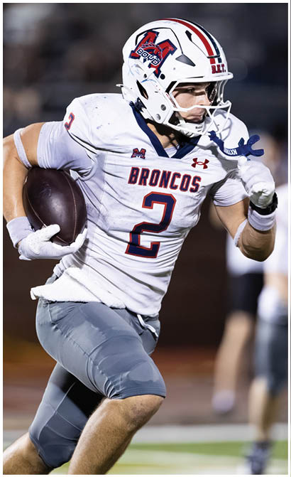 A football player running on the field. Description generated by AI