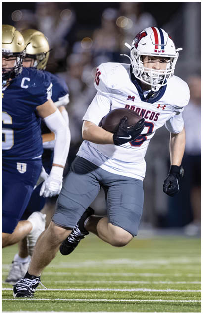 A football player running on the field. Description generated by AI