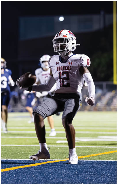 A football player running on the field. Description generated by AI