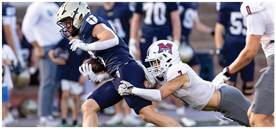 A football player is sliding on the ground. Description generated by AI