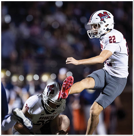 A football player running on the field. Description generated by AI
