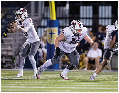 A football player running on the field. Description generated by AI