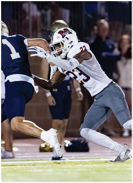 A football player running on the field. Description generated by AI