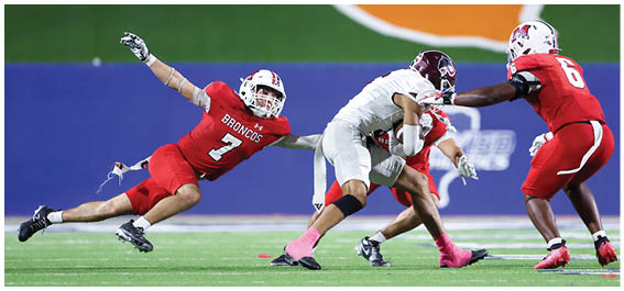 A football player is sliding on the ground. Description generated by AI