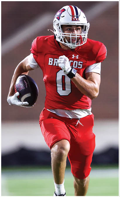 A football player running on the field. Description generated by AI