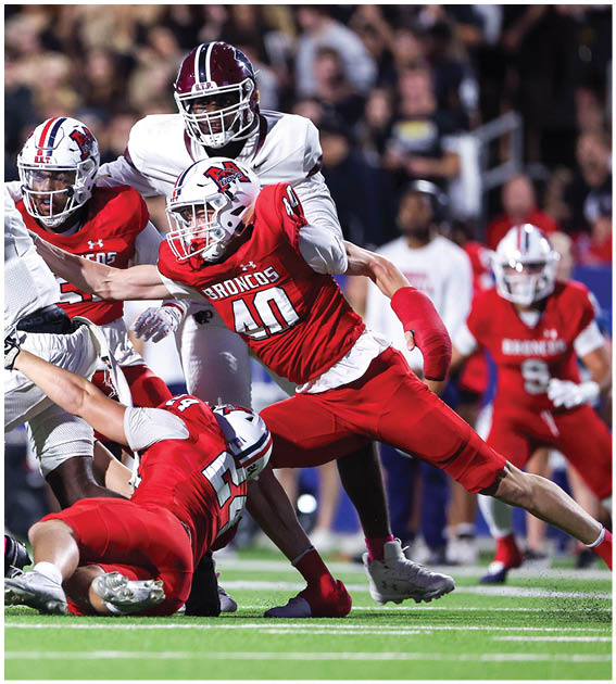 A group of football players wearing black and white uniforms. Description generated by AI