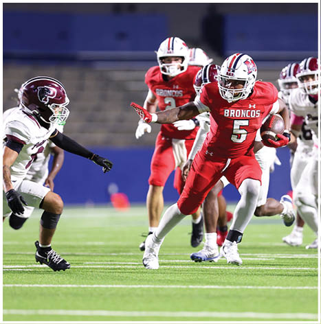 A football player running on the field. Description generated by AI
